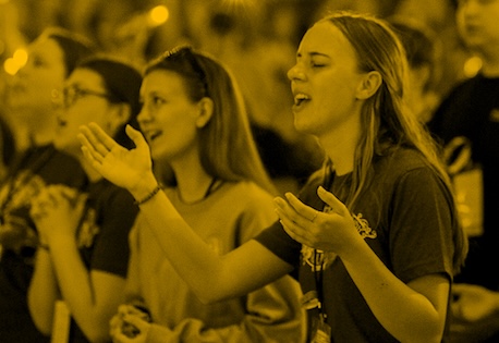 photograph with hands holding a cross
